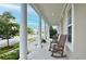 Spacious front porch with classic rocking chairs and elegant pillars, providing a welcoming outdoor living space at 1855 Treasure Cv, Kissimmee, FL 34747