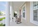 Relaxing front porch featuring rocking chairs, offering a perfect spot to unwind and enjoy the neighborhood views at 1855 Treasure Cv, Kissimmee, FL 34747