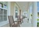 Charming front porch with rocking chairs and columns offers a relaxing outdoor space at 1855 Treasure Cv, Kissimmee, FL 34747