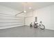 Clean garage featuring an epoxy floor, bright lighting and space for parking or storage at 1855 Treasure Cv, Kissimmee, FL 34747