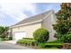 Exterior view of the home's garage with well-maintained landscaping around the property at 1855 Treasure Cv, Kissimmee, FL 34747