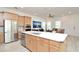 Open kitchen boasts stainless appliances, central island, and a seamless transition to the living area at 1855 Treasure Cv, Kissimmee, FL 34747