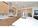 Bright kitchen features stainless appliances, light wood cabinets, quartz counters and modern backsplash at 1855 Treasure Cv, Kissimmee, FL 34747
