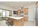 Modern kitchen island with seating, stainless appliances and light wood cabinets offering a sleek design at 1855 Treasure Cv, Kissimmee, FL 34747