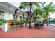 Outdoor poolside bar with seating and dining options, surrounded by lush landscaping and views of the clubhouse at 1855 Treasure Cv, Kissimmee, FL 34747