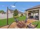 Charming backyard features a fire pit area, covered patio, and lush landscaping, perfect for outdoor entertaining at 1864 Castleton Dr, St Cloud, FL 34771
