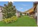 A lush green backyard with mature landscaping, string lights, and a shaded seating area at 1864 Castleton Dr, St Cloud, FL 34771