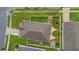 An aerial view of a well-kept backyard with a fire pit, small storage shed, and green space at 1864 Castleton Dr, St Cloud, FL 34771