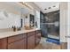Beautiful bathroom featuring a dark tiled shower, wood-look tile flooring, and wood vanity at 1864 Castleton Dr, St Cloud, FL 34771