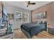 Comfortable bedroom with two windows, hardwood floors, and a brick accent wall, creating a cozy retreat at 1864 Castleton Dr, St Cloud, FL 34771