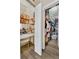 Walk-in closet with custom shelving and dressing table, providing ample storage space at 1864 Castleton Dr, St Cloud, FL 34771