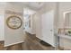 Inviting hallway with neutral walls, decorative accents, and wood-look flooring leading to other rooms at 1864 Castleton Dr, St Cloud, FL 34771