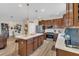 Spacious kitchen featuring wood cabinetry, stainless steel appliances, and a center island with bar stool seating at 1864 Castleton Dr, St Cloud, FL 34771