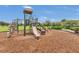Community playground featuring climbing equipment, slides, and soft ground cover in a park-like setting at 1864 Castleton Dr, St Cloud, FL 34771