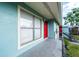 Apartment balcony with light blue siding and a red door at 1891 Caralee Blvd # 3, Orlando, FL 32822