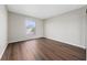 A cozy bedroom with hardwood floors and a sunlit window at 1891 Caralee Blvd # 3, Orlando, FL 32822