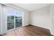 Bedroom with laminate wood floor and sliding glass doors leading to a deck at 1891 Caralee Blvd # 3, Orlando, FL 32822