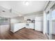 Bright kitchen with white cabinetry and appliances next to living room area at 1891 Caralee Blvd # 3, Orlando, FL 32822
