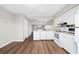 Kitchen featuring white cabinets and appliances next to the living room at 1891 Caralee Blvd # 3, Orlando, FL 32822