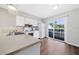 Kitchen with white appliances and cabinets, and a sliding glass door at 1891 Caralee Blvd # 3, Orlando, FL 32822