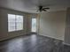 Neutral living room with gray wood floors, a ceiling fan, and lots of natural light at 2030 Cascades Blvd # 204, Kissimmee, FL 34741