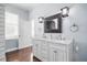 Bathroom with double sink vanity, granite countertop and decorative mirror at 205 N Village St, Celebration, FL 34747