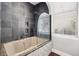 Modern bathroom features a soaking tub with slate surround and rainfall shower head at 205 N Village St, Celebration, FL 34747