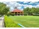Community gazebo with picnic tables set among a green lawn and mature trees at 205 N Village St, Celebration, FL 34747