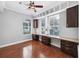 Bright home office with custom built-in shelving, ample workspace, and hardwood floors for a professional setting at 205 N Village St, Celebration, FL 34747