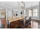 Spacious kitchen with a central island, stainless steel sink, and hardwood floors, ideal for cooking and entertaining at 205 N Village St, Celebration, FL 34747