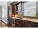 Stylish kitchen with granite countertops, stainless steel appliances, and dark wood cabinetry for a modern look at 205 N Village St, Celebration, FL 34747