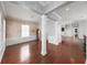 Spacious living room with hardwood floors, decorative columns, and large windows for plenty of natural light at 205 N Village St, Celebration, FL 34747