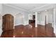 Elegant living room with hardwood floors, architectural details, and an open layout flowing into the kitchen at 205 N Village St, Celebration, FL 34747