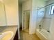 Bright bathroom with ceramic tile floor, bath tub with shower and single sink vanity at 2243 Seven Oaks Dr, St Cloud, FL 34772