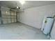 Clean and spacious garage featuring cement floor, white walls and garage door at 2243 Seven Oaks Dr, St Cloud, FL 34772