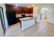 Modern kitchen with stainless steel appliances, dark cabinets, and tile flooring at 2243 Seven Oaks Dr, St Cloud, FL 34772
