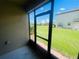 Relaxing view from screened patio of the lush green lawn and neighboring building at 2243 Seven Oaks Dr, St Cloud, FL 34772