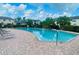 Resort-style pool surrounded by lush landscaping and lounge chairs at 2243 Seven Oaks Dr, St Cloud, FL 34772