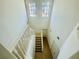 Bright view of the white banister staircase with high ceilings and natural light at 2243 Seven Oaks Dr, St Cloud, FL 34772