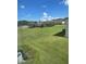 Serene view of green lawn and playground featuring beautiful blue sky and white clouds at 2243 Seven Oaks Dr, St Cloud, FL 34772