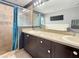 Bathroom featuring a double sink vanity, large mirror, soaking tub and a walk-in shower at 2444 Oak Mill Dr, Kissimmee, FL 34744