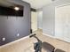 Bedroom featuring tile floor, a bench press with weights, a ceiling fan, and a flat screen TV at 2444 Oak Mill Dr, Kissimmee, FL 34744