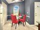 Cozy breakfast nook with glass table, red chairs, tile floors, and large window offering great natural light at 2444 Oak Mill Dr, Kissimmee, FL 34744