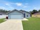 Charming single-story home features a well-manicured lawn, a two-car garage, and a classic facade at 2444 Oak Mill Dr, Kissimmee, FL 34744