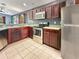 Modern kitchen with stainless steel appliances, rich wood cabinets, and ample counter space for cooking at 2444 Oak Mill Dr, Kissimmee, FL 34744