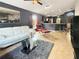 Stylish living area showcases tile floors, contemporary furniture, and a view into the kitchen at 2444 Oak Mill Dr, Kissimmee, FL 34744
