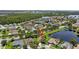 This aerial showcases the home's peaceful neighborhood near a serene lake at 2612 Keswick Ct, Kissimmee, FL 34744