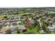 This aerial view shows the property backing up to the lake with a golf course in the background at 2612 Keswick Ct, Kissimmee, FL 34744