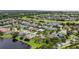 An aerial view highlighting the home's location within a lush, tree-filled neighborhood near a golf course at 2612 Keswick Ct, Kissimmee, FL 34744
