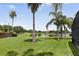 Beautiful backyard view featuring a pond, mature trees, and lush green lawn at 2612 Keswick Ct, Kissimmee, FL 34744